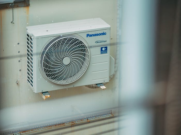 Panasonic ductless mini-split outdoor condenser unit mounted on an exterior wall